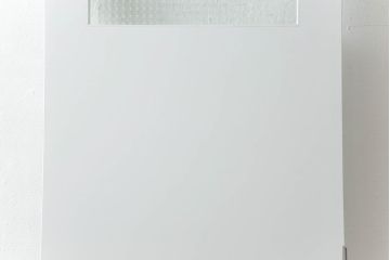 ドアを窓付ドアにリメイク!既存の小さな丸窓は穴埋めし、上部にチェッカーガラスをはめ込み明り取りを制作。