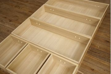 2段重ね桐箪笥をリビングボードとチェストにリメイク!上段は中央の仕切りと棚板を製作。取っ手を付け替え、本体をアンティークホワイトにペイント。下段は下2杯分をカットし、自然な木地色仕上げに。いずれも天板と脚を取り付け。